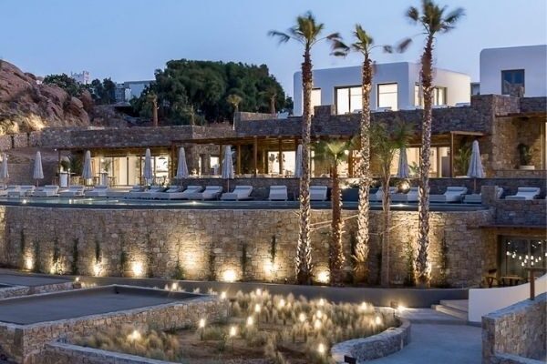 Maximus Mykonos hotel terraces and palm trees at dusk